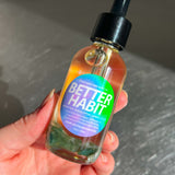 Hand holding a bottle labeled 'Better Habit' against a neutral background