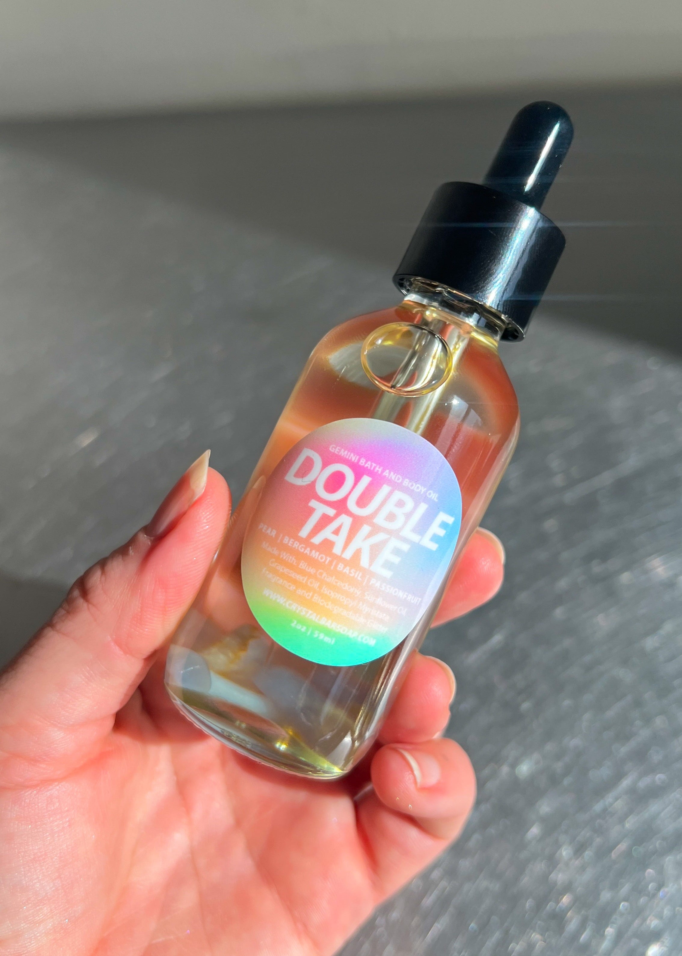 Hand holding a bottle labeled 'Double Take' with a colorful label.