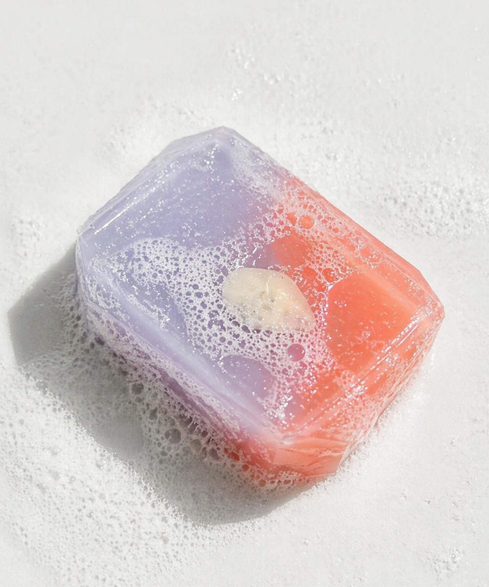 Colorful soap bar with bubbles on a white background
