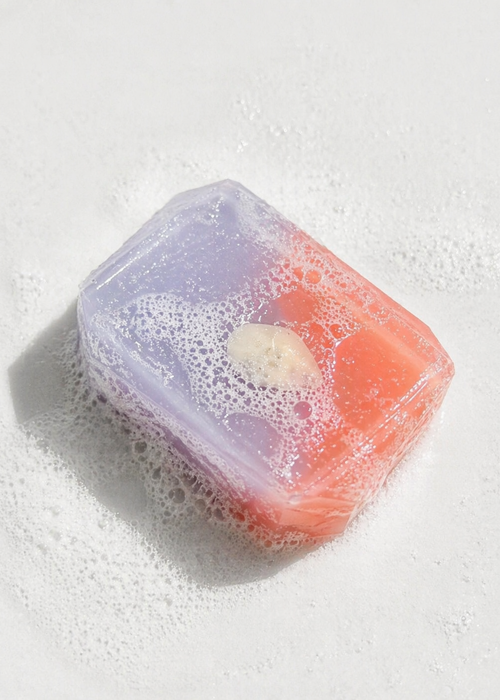 Colorful soap bar with bubbles on a white background