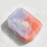 Colorful soap bar with bubbles on a white background