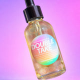 Bottle labeled 'Double Take' with a colorful label on a gradient background